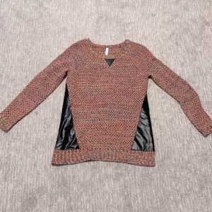 Pink sweater with black faux leather panels